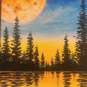 Silhouetted trees reflect in a lake at sunset.