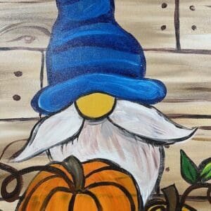 Gnome with a blue hat holding pumpkins.