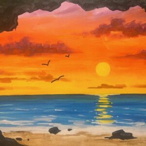Sunset over ocean with birds flying.