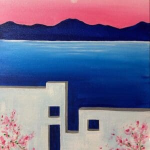 White coastal buildings, blue sea, pink sky